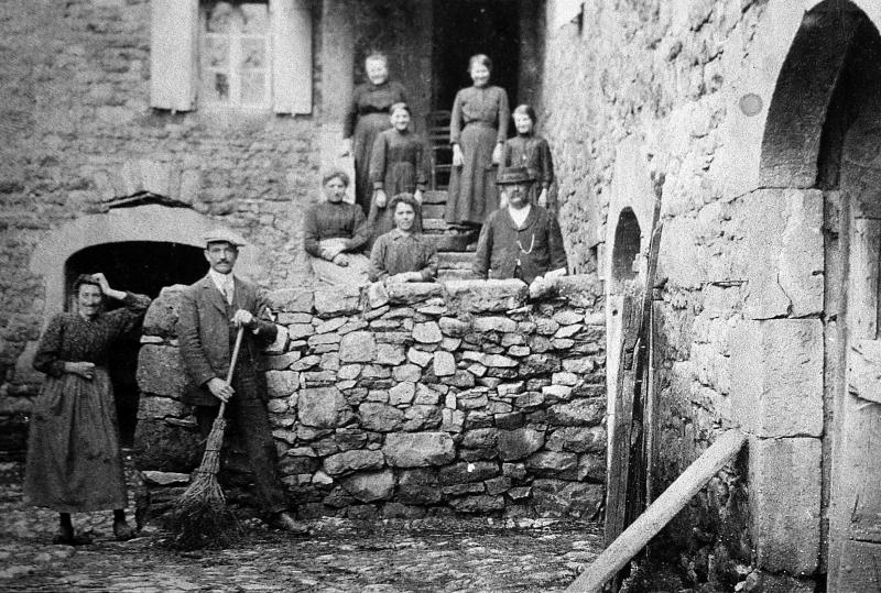 Famille dans escalier en pierre, en Aubrac (secteur de Laguiole)