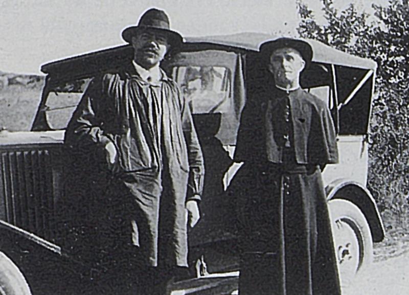 Homme et curé (curat) en soutane devant une automobile (veitura)