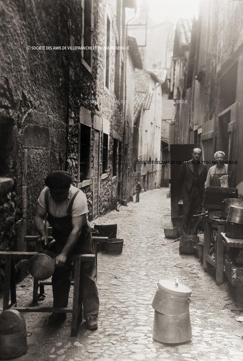  Chaudronnier (pairolièr) travaillant une marmite en cuivre (ola) devant son atelier, 1949