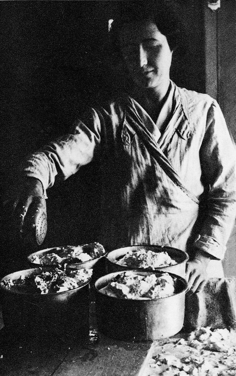 Femme salant de la pâte à fromage contenue dans des moules (faissèlas)